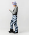 studio on-model image of strafe outerwear 2023 strafe x shredly scarlett bib in tie dye splatter color