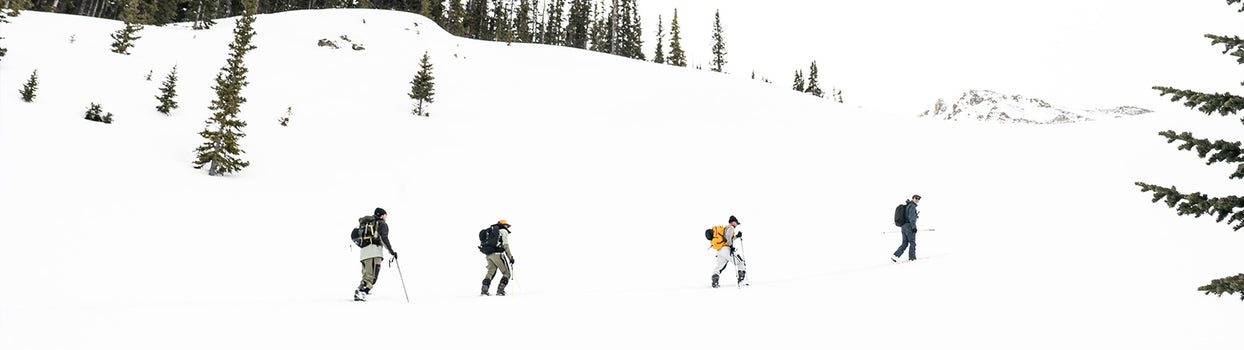 group of 4 skiers touring