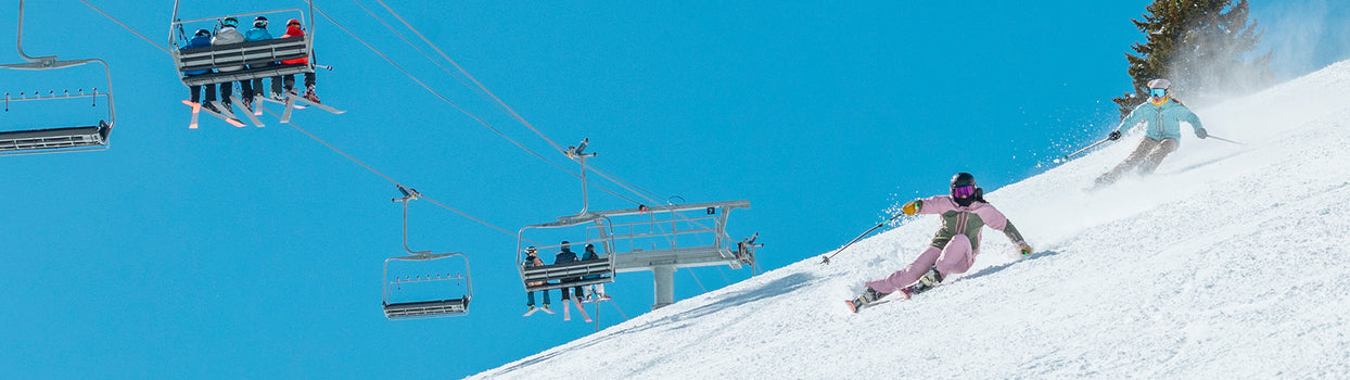happy strafe skiers on a groomer