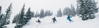 three friends skiing pow