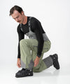 on-model image of strafe outerwear fall/winter 23/24 collection mens nomad bib pant in moss