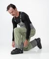 on-model image of strafe outerwear fall/winter 23/24 collection mens nomad bib pant in moss 