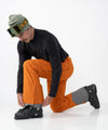 on-model image of strafe outerwear fall/winter 23/24 collection mens summit pant in amber 