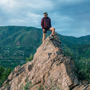 male on peak summit looking down