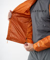 on-model image of strafe outerwear fall/winter 23/24 collection mens ultralight aero hooded insulator in amber