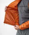 on-model image of strafe outerwear fall/winter 23/24 collection mens ultralight aero hooded insulator in amber 