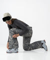 on-model image of strafe outerwear fall/winter 23/24 collection womens pika pant in distressed moss camo