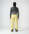 on-model image of strafe outerwear fall/winter 23/24 collection womens scarlett bib pant in lemon