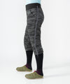 on-model image of strafe outerwear fall/winter 23/24 collection womens alpha insulator pant in distressed stealth camo