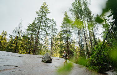smiling female runner through trees
