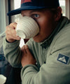 hunter hill drinking coffee in the ajax snap fleece