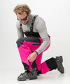 studio on-model image of strafe outerwear 2023 nomad 3l shell bib in fuchsia color