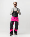studio on-model image of strafe outerwear 2023 nomad 3l shell bib in fuchsia color