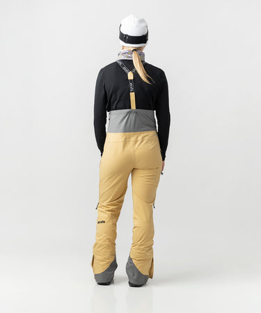 studio on-model image of strafe outerwear 2023 willow 3l shell half bib in dune color