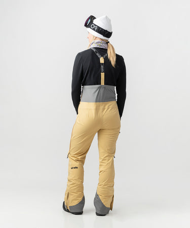 studio on-model image of strafe outerwear 2023 willow 3l shell half bib in dune color