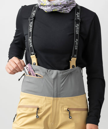 studio on-model image of strafe outerwear 2023 willow 3l shell half bib in dune color