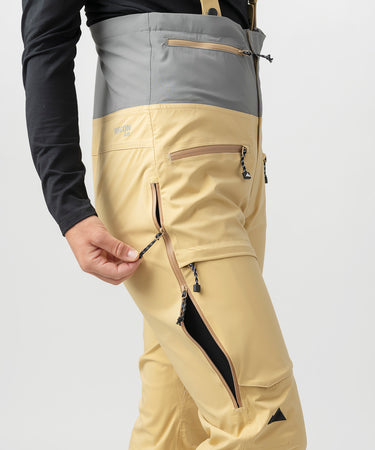 studio on-model image of strafe outerwear 2023 willow 3l shell half bib in dune color
