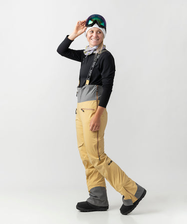 studio on-model image of strafe outerwear 2023 willow 3l shell half bib in dune color